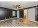Spacious bedroom with a ceiling fan, natural light, luxury vinyl plank floors, and stylish barn doors at 12661 Doe Ln, Indianapolis, IN 46236