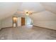 Large bonus room featuring neutral carpeting, doors, and ceiling fan at 12661 Doe Ln, Indianapolis, IN 46236
