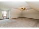 Large bonus room featuring neutral carpeting, a window, and ceiling fan at 12661 Doe Ln, Indianapolis, IN 46236