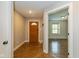Inviting entryway showcasing beautiful wood floors, a charming wood door and light gray walls at 12661 Doe Ln, Indianapolis, IN 46236