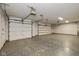 Garage with epoxy flooring, two garage doors, and plenty of overhead lighting at 12661 Doe Ln, Indianapolis, IN 46236