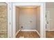 A view of the laundry room, which features neutral walls, hardwood floors and a door to the exterior at 12661 Doe Ln, Indianapolis, IN 46236