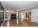 Spacious living room with a cozy fireplace, hardwood floors, and abundant natural light at 12661 Doe Ln, Indianapolis, IN 46236