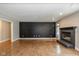 Open-concept living area featuring a stylish accent wall, a fireplace, and hardwood floors at 12661 Doe Ln, Indianapolis, IN 46236