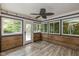 Enclosed sunroom with multiple windows for great natural light and wood paneling at 12661 Doe Ln, Indianapolis, IN 46236