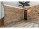 Enclosed sunroom with brick siding, light fixtures, and a ceiling fan at 12661 Doe Ln, Indianapolis, IN 46236