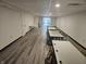 View of basement meeting room with several tables lined up in rows and light gray vinyl flooring at 1267 W 750 S, Trafalgar, IN 46181