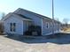 Well-maintained one-story building with light gray siding, and a gravel driveway at 1267 W 750 S, Trafalgar, IN 46181