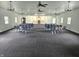 View of an interior room with rows of gray chairs, dark carpet, and several ceiling fans at 1267 W 750 S, Trafalgar, IN 46181