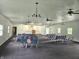 View of a meeting room with light walls, dark carpet and several rows of gray chairs at 1267 W 750 S, Trafalgar, IN 46181