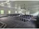 View of a meeting space with rows of gray chairs and a raised platform with a podium on it at 1267 W 750 S, Trafalgar, IN 46181