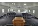 View of the meeting space with new gray carpet and neutral walls and rows of chairs facing a wooden podium at 1267 W 750 S, Trafalgar, IN 46181