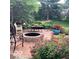 Beautiful backyard patio with chairs, table, fire pit, and colorful flowers at 1273 Helford Ln, Carmel, IN 46032