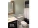 Well-lit bathroom features a modern vanity, mirror, and shower with a black and white curtain at 1273 Helford Ln, Carmel, IN 46032