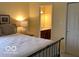 Bedroom featuring a bed and a doorway leading to a bathroom at 1273 Helford Ln, Carmel, IN 46032