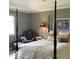 Bedroom with a four-poster bed, wingback chair, and large window with natural light at 1273 Helford Ln, Carmel, IN 46032
