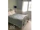 Bright bedroom with a metal bed frame, large window, and neutral carpet, offering a serene space at 1273 Helford Ln, Carmel, IN 46032