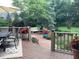 Spacious deck with outdoor seating, potted flowers, and a view of the lush backyard at 1273 Helford Ln, Carmel, IN 46032