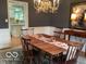 Charming dining room with chandelier, wood table, and kitchen view at 1273 Helford Ln, Carmel, IN 46032