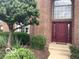 Elegant front entrance with a burgundy door, a large transom window and meticulous landscaping at 1273 Helford Ln, Carmel, IN 46032