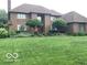 Beautiful brick home with a large front lawn and meticulously maintained landscaping at 1273 Helford Ln, Carmel, IN 46032