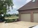 Attached two car garage with a paved driveway and landscaping at 1273 Helford Ln, Carmel, IN 46032