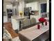 Open kitchen with island, seating, and stainless steel appliances at 1273 Helford Ln, Carmel, IN 46032