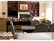 Bright living area featuring a fireplace, built-in shelving, and inviting furnishings at 1273 Helford Ln, Carmel, IN 46032