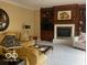 Cozy living room showcasing a fireplace, built-in shelving, and comfortable seating at 1273 Helford Ln, Carmel, IN 46032