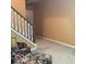 Living room with a wooden staircase, carpeted floors, and a floral upholstered seat at 1273 Helford Ln, Carmel, IN 46032