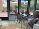 Relaxing sunroom with chairs, a table, an area rug, and views of the surrounding nature at 1273 Helford Ln, Carmel, IN 46032