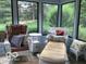 Cozy sunroom filled with wicker furniture and comfortable pillows at 1273 Helford Ln, Carmel, IN 46032