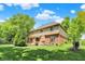 A sprawling backyard with a well-manicured lawn and mature trees provides privacy and a serene view of the home's exterior at 1377 Sedona Dr, Carmel, IN 46032