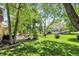 Serene backyard setting with a hammock, mature trees, and a glimpse of the neighbor's house in the background at 1377 Sedona Dr, Carmel, IN 46032