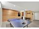 Basement with a ping pong table, dining set, and wood accent wall, perfect for entertainment at 1377 Sedona Dr, Carmel, IN 46032