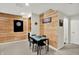 Basement rec room with dining table, dart board, wood accent wall and stylish decor at 1377 Sedona Dr, Carmel, IN 46032