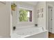 Inviting bathroom featuring a large soaking tub and a view to the outside at 1377 Sedona Dr, Carmel, IN 46032