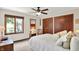 Cozy bedroom featuring a large window, a ceiling fan, and a comfortable bed with white linens and decorative pillows at 1377 Sedona Dr, Carmel, IN 46032