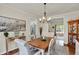 Elegant dining room with wood floors, crown molding, a wood table, and seating for six at 1377 Sedona Dr, Carmel, IN 46032