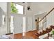 Grand foyer with hardwood floors, a staircase, and a large window allowing ample natural light at 1377 Sedona Dr, Carmel, IN 46032
