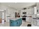 Bright kitchen featuring white cabinets, granite countertops, a central island, and stainless steel appliances at 1377 Sedona Dr, Carmel, IN 46032