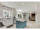 Bright kitchen featuring granite counters, stainless appliances, an island with blue accents, and white cabinets at 1377 Sedona Dr, Carmel, IN 46032
