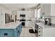 Bright kitchen featuring granite counters, stainless appliances, an island with blue accents, and white cabinets at 1377 Sedona Dr, Carmel, IN 46032