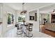 Bright eat-in kitchen with a dark wood table, bar stool seating, and access to the living room at 1377 Sedona Dr, Carmel, IN 46032