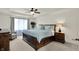 Spacious primary bedroom with a ceiling fan, large window, and paneled accent wall at 1377 Sedona Dr, Carmel, IN 46032