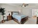 Well-lit primary bedroom with a ceiling fan, a window view and modern decor at 1377 Sedona Dr, Carmel, IN 46032