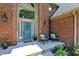 Charming front porch with a welcoming blue door, decorative plants, and comfortable seating at 1377 Sedona Dr, Carmel, IN 46032