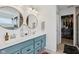 Bright bathroom featuring double sinks, stylish round mirrors, and a walk-in closet at 1414 W Springhurst Blvd, Greenfield, IN 46140