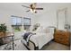 Well-lit bedroom with two large windows, a ceiling fan, a desk, and neutral carpet at 1414 W Springhurst Blvd, Greenfield, IN 46140