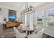 Open floor plan view of the dining area featuring a modern light fixture and hardwood floors at 1414 W Springhurst Blvd, Greenfield, IN 46140
